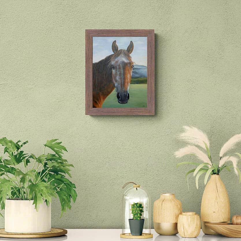 Roan horse portrait painting above cabinet with plants and wooden ornaments